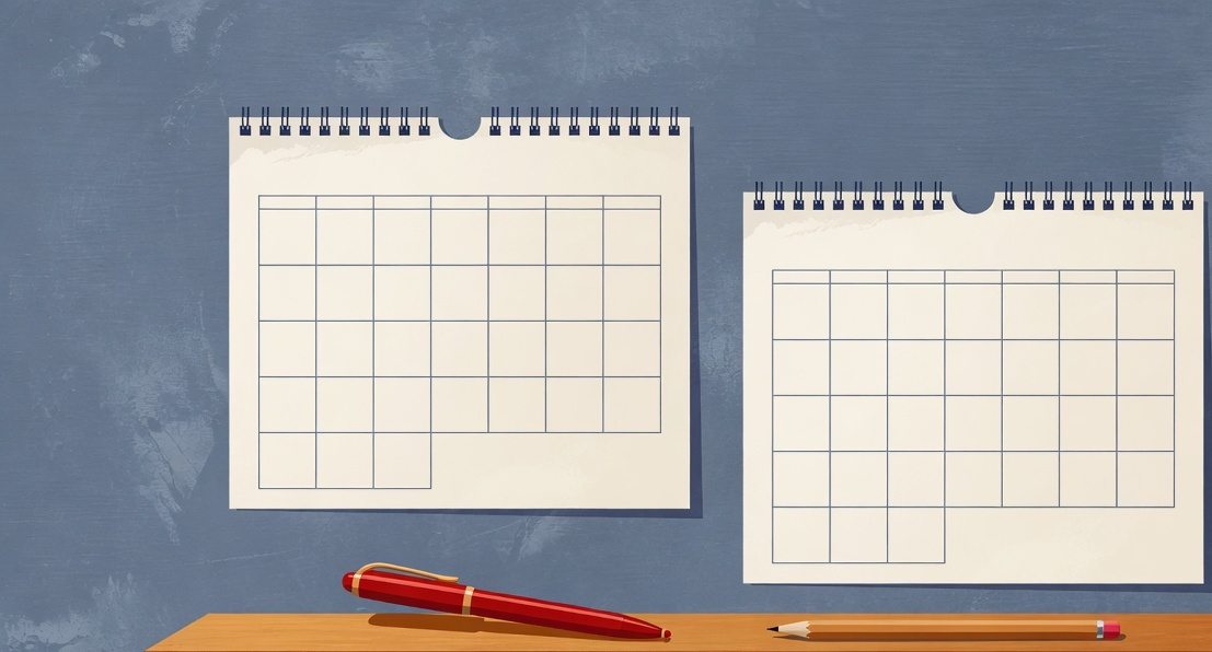 Two paper calendars side by side on a desk with a pen marking a two-week test window across both