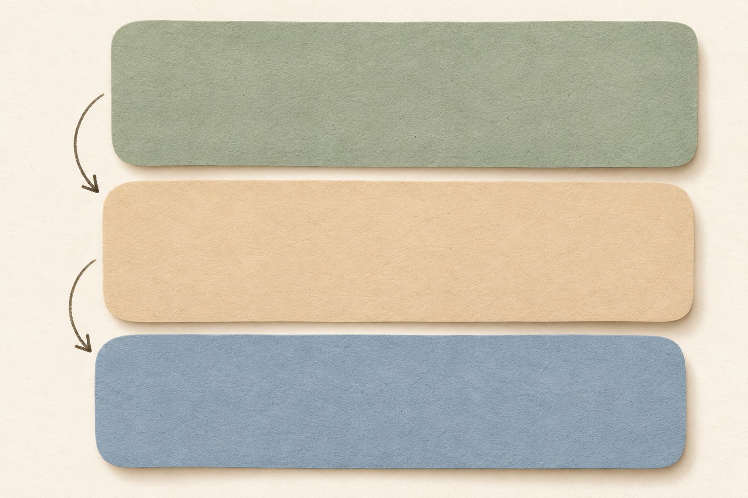 Three stacked blank panels on a desk, suggesting three editing passes, with no readable text
